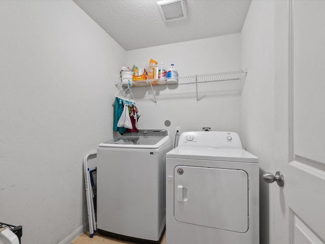 20819 Mount Bauer Dr, Hockley, TX 77447 - clothes washing area featuring baseboards, visible vents, washer and dryer, and laundry area