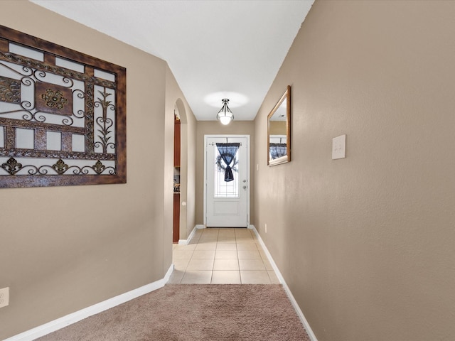 20819 Mount Bauer Dr, Hockley, TX 77447 - entryway featuring baseboards, arched walkways, light colored carpet, and light tile patterned flooring