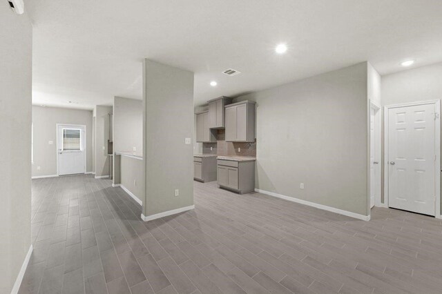 26400 Cooperstown Way, Splendora, TX 77372 - unfurnished living room featuring light wood-style flooring and baseboards