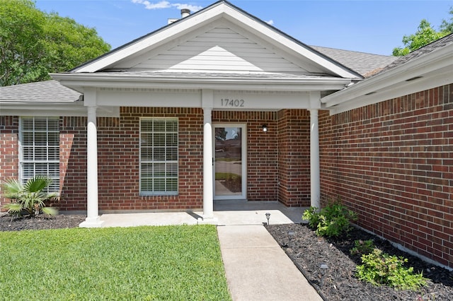 17402 Eastwood Cir, Houston, TX 77095 - entrance to property with brick siding, a shingled roof, and a lawn