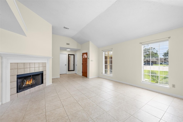 17402 Eastwood Cir, Houston, TX 77095 - unfurnished living room featuring lofted ceiling, light tile patterned floors, a tile fireplace, and baseboards