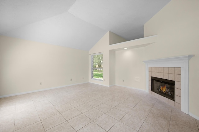 17402 Eastwood Cir, Houston, TX 77095 - unfurnished living room featuring a tiled fireplace, light tile patterned floors, high vaulted ceiling, and baseboards