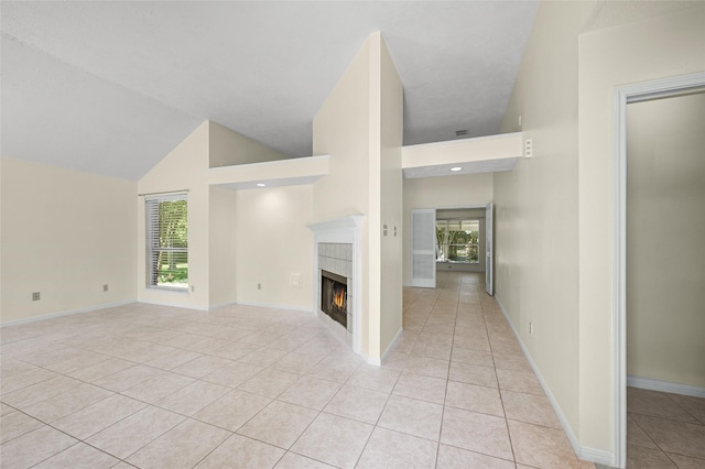 17402 Eastwood Cir, Houston, TX 77095 - unfurnished living room with light tile patterned flooring, a tiled fireplace, high vaulted ceiling, and baseboards