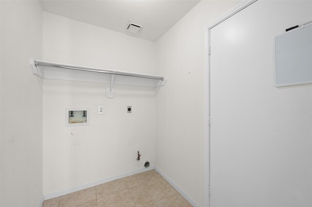 17402 Eastwood Cir, Houston, TX 77095 - laundry area featuring hookup for a gas dryer, hookup for a washing machine, baseboards, hookup for an electric dryer, and light tile patterned floors