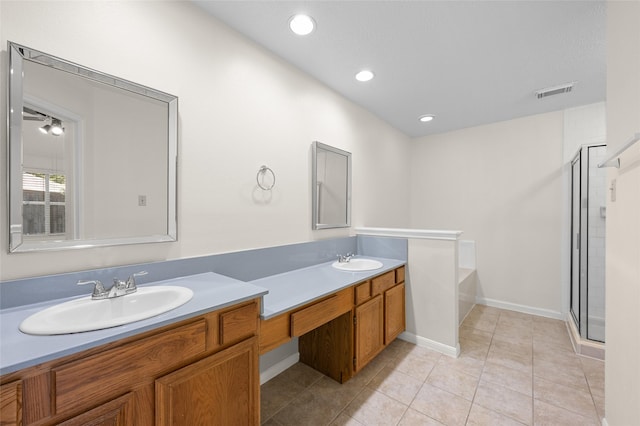17402 Eastwood Cir, Houston, TX 77095 - bathroom featuring double vanity, a bath, a shower stall, tile patterned flooring, and recessed lighting