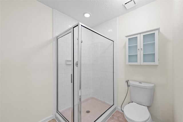 17402 Eastwood Cir, Houston, TX 77095 - bathroom with a shower stall, baseboards, toilet, and a textured ceiling