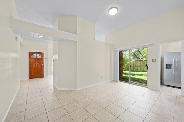 17402 Eastwood Cir, Houston, TX 77095 - spare room with light tile patterned floors, baseboards, and a high ceiling