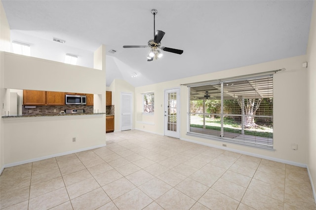 17402 Eastwood Cir, Houston, TX 77095 - unfurnished living room featuring a ceiling fan, high vaulted ceiling, light tile patterned flooring, and baseboards