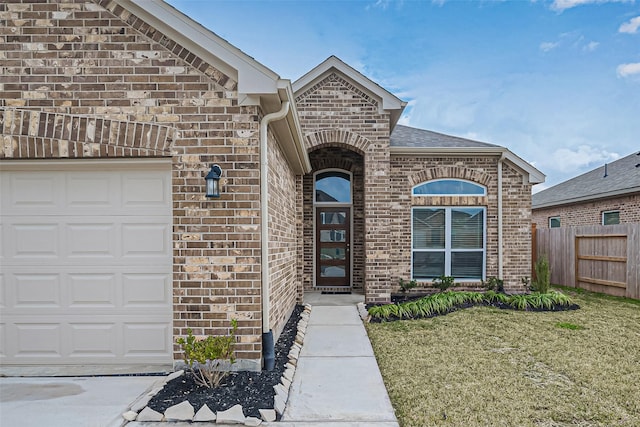 view of front of home with roof with shingles, a front lawn, fence, a garage, and brick siding