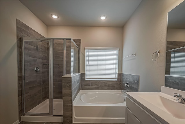 full bath featuring a shower stall, recessed lighting, a bath, and vanity