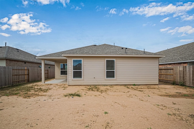 back of property featuring a patio area and a fenced backyard