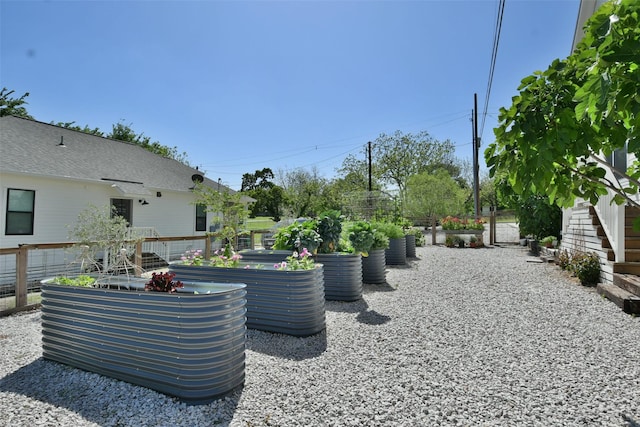 view of yard with fence and a vegetable garden