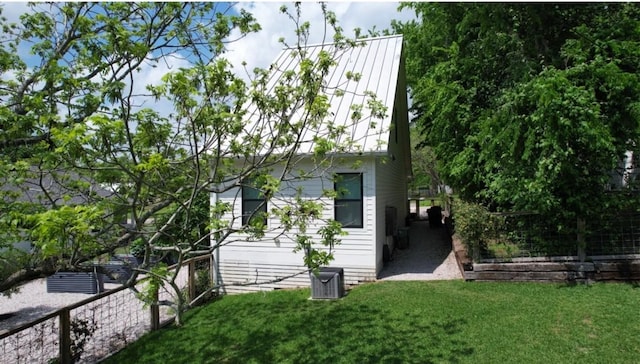 view of property exterior featuring a yard and central air condition unit