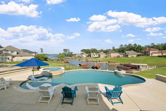 18762 Grand Harbor Pt, Montgomery, TX 77356 - view of swimming pool featuring a patio area, a residential view, a pool with connected hot tub, and a water view