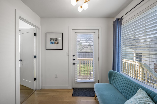 2407 Stonecrest Dr, Houston, TX 77018 - doorway to outside with a notable chandelier, baseboards, and wood finished floors