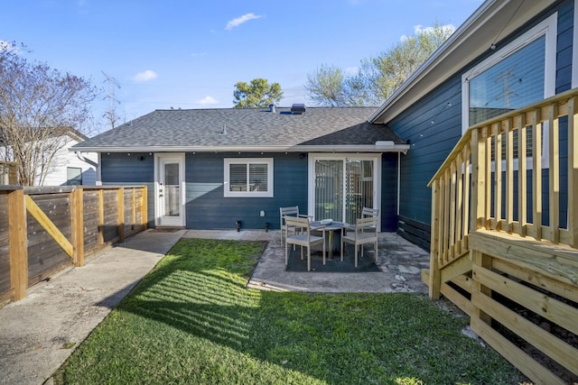 2407 Stonecrest Dr, Houston, TX 77018 - back of property featuring a yard, a patio area, roof with shingles, and a fenced backyard