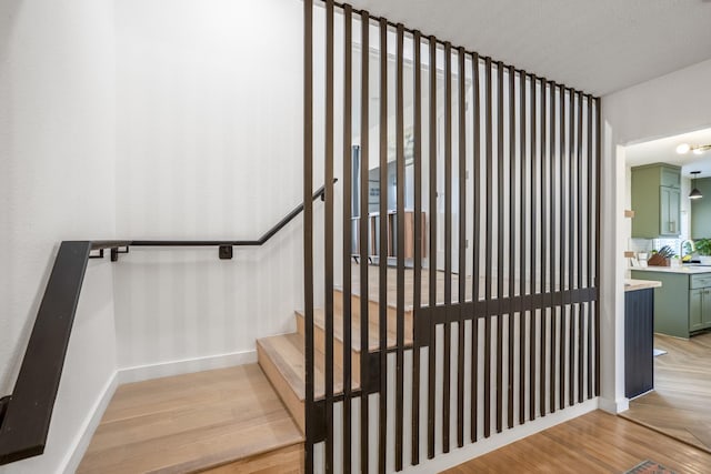 2407 Stonecrest Dr, Houston, TX 77018 - stairway featuring baseboards and wood finished floors