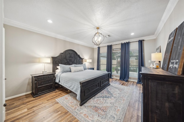 bedroom featuring crown molding, a notable chandelier, and wood finished floors