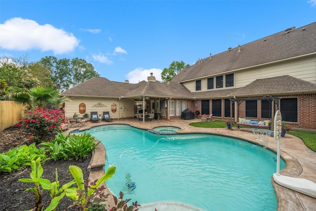 view of pool featuring a fenced in pool, a patio, an in ground hot tub, and fence