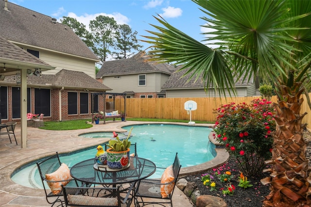 view of swimming pool with a fenced backyard, a patio, a fenced in pool, and an in ground hot tub