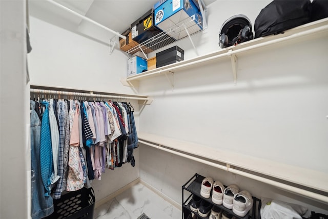 spacious closet with marble finish floor