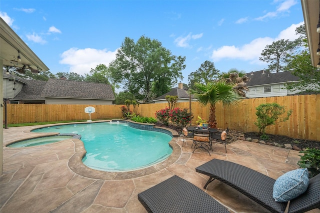 view of swimming pool with a fenced backyard, a patio, a pool with connected hot tub, and outdoor dining area