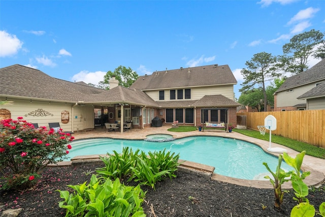 view of swimming pool featuring a fenced backyard, grilling area, a patio area, and a pool with connected hot tub