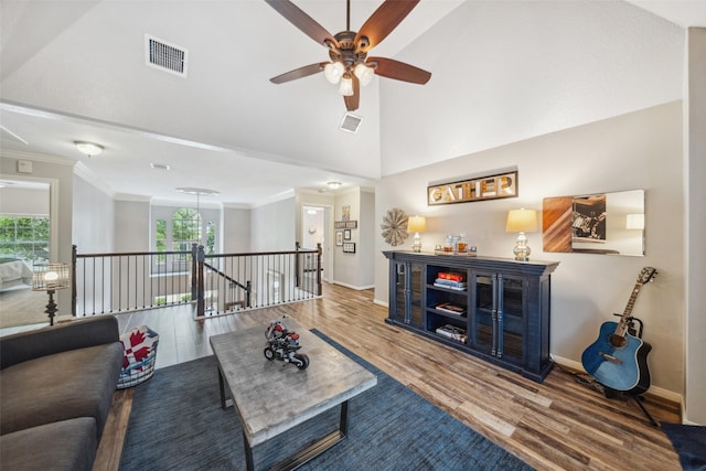 living room featuring wood finished floors, visible vents, a wealth of natural light, and ceiling fan