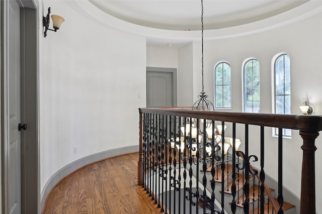 2419 Briarhurst Dr, Houston, TX 77057 - corridor featuring an upstairs landing, wood finished floors, and a chandelier