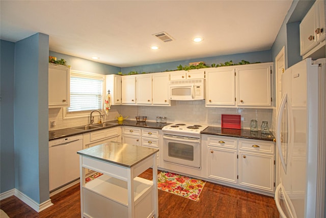 kitchen featuring a sink, dark wood-style flooring, visible vents, backsplash, and white appliances