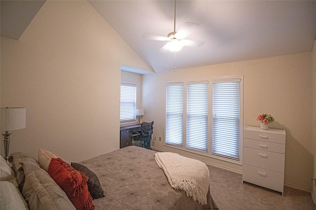 bedroom with vaulted ceiling, carpet flooring, and a ceiling fan