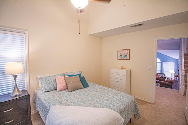 carpeted bedroom featuring ceiling fan and visible vents