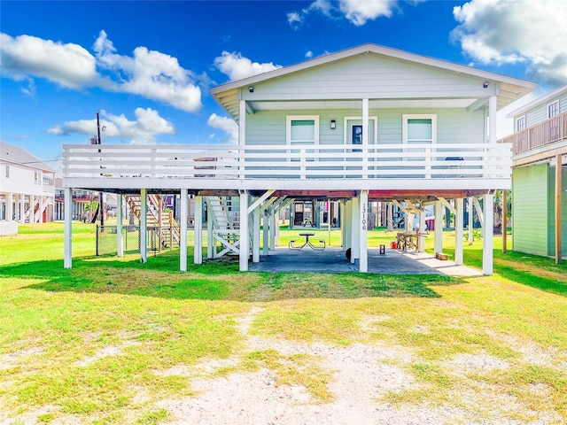 13106 Coronado Dr, Freeport, TX 77541 - rear view of property with a carport, a lawn, and stairway
