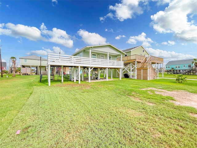13106 Coronado Dr, Freeport, TX 77541 - back of property featuring a lawn, stairs, and a deck