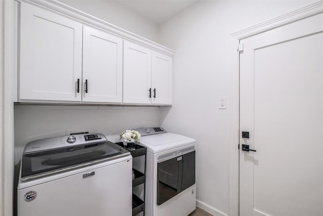 laundry area with cabinet space and washing machine and clothes dryer