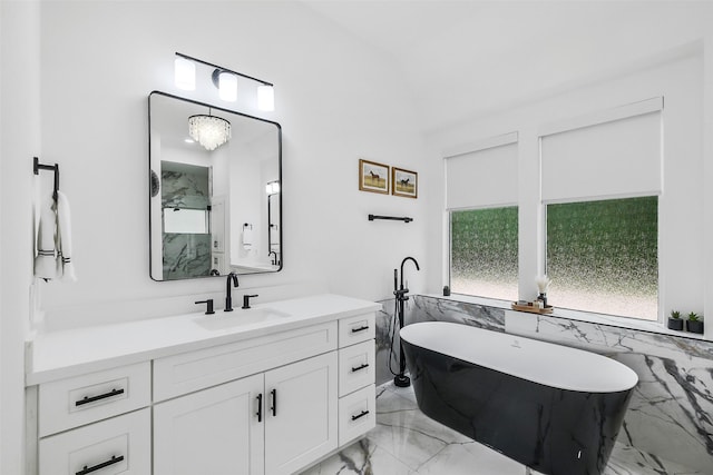 bathroom featuring vanity, a marble finish shower, marble finish floor, a freestanding tub, and tile walls