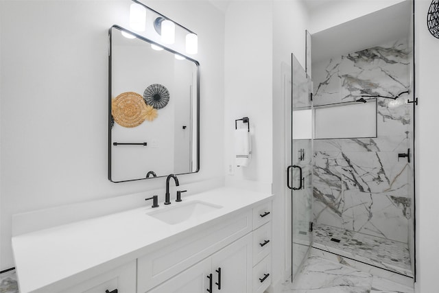 full bath with vanity, marble finish floor, and a marble finish shower