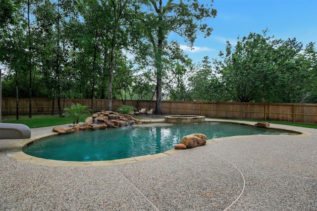 view of swimming pool featuring a fenced backyard, a patio, a pool with connected hot tub, and a water slide