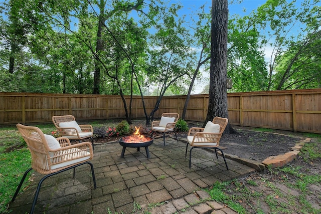 view of patio with a fenced backyard and an outdoor fire pit