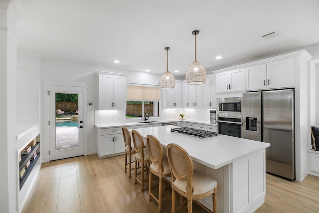 kitchen featuring visible vents, a sink, a healthy amount of sunlight, and stainless steel appliances