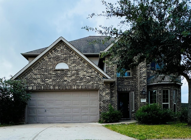 french country style house featuring concrete driveway, brick siding, roof with shingles, and a garage