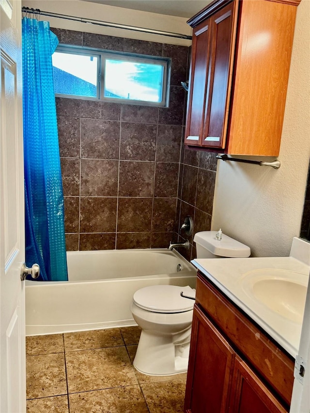 full bath with shower / bath combo, toilet, vanity, and tile patterned floors