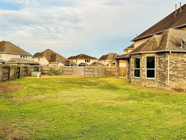 view of yard with a residential view and a fenced backyard