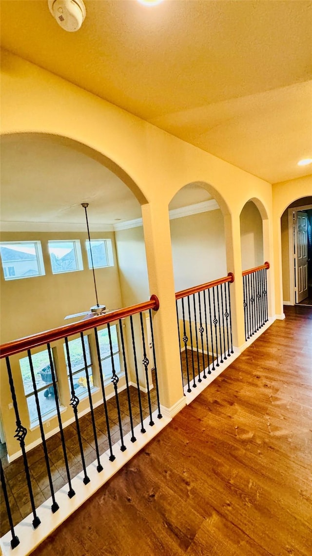 corridor with baseboards, wood finished floors, and recessed lighting