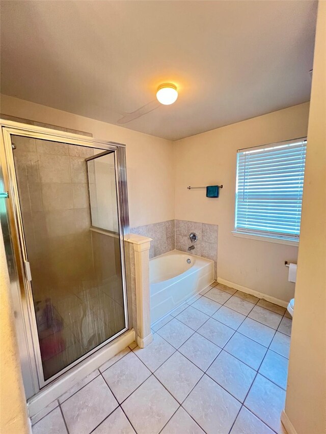 6022 Yorkglen Manor Ln, Houston, TX 77084 - bathroom with a garden tub, tile patterned floors, a stall shower, and baseboards