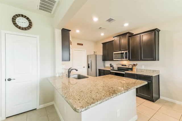 kitchen with stainless steel appliances, a sink, light tile patterned flooring, baseboards, and visible vents