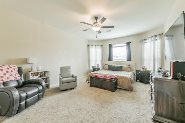 carpeted bedroom featuring visible vents, a ceiling fan, and baseboards