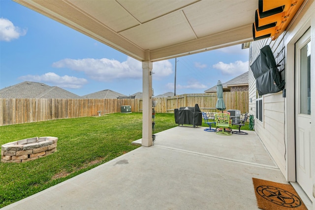 view of patio featuring a fenced backyard, grilling area, and an outdoor fire pit