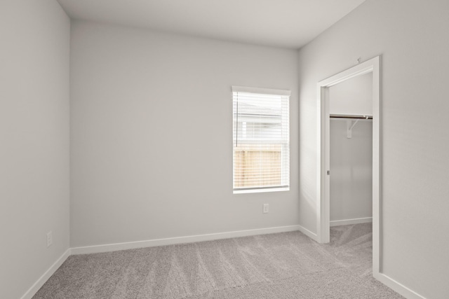 17832 Lionheart Rd, Conroe, TX 77306 - unfurnished bedroom featuring carpet, a spacious closet, and baseboards