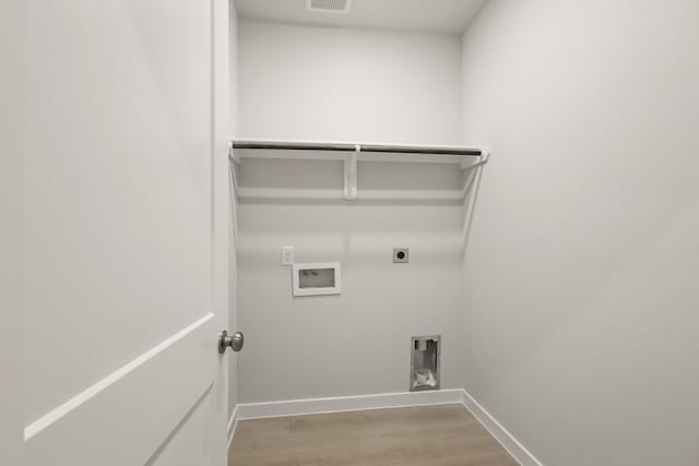 17832 Lionheart Rd, Conroe, TX 77306 - laundry area featuring electric dryer hookup, hookup for a washing machine, light wood-type flooring, and baseboards